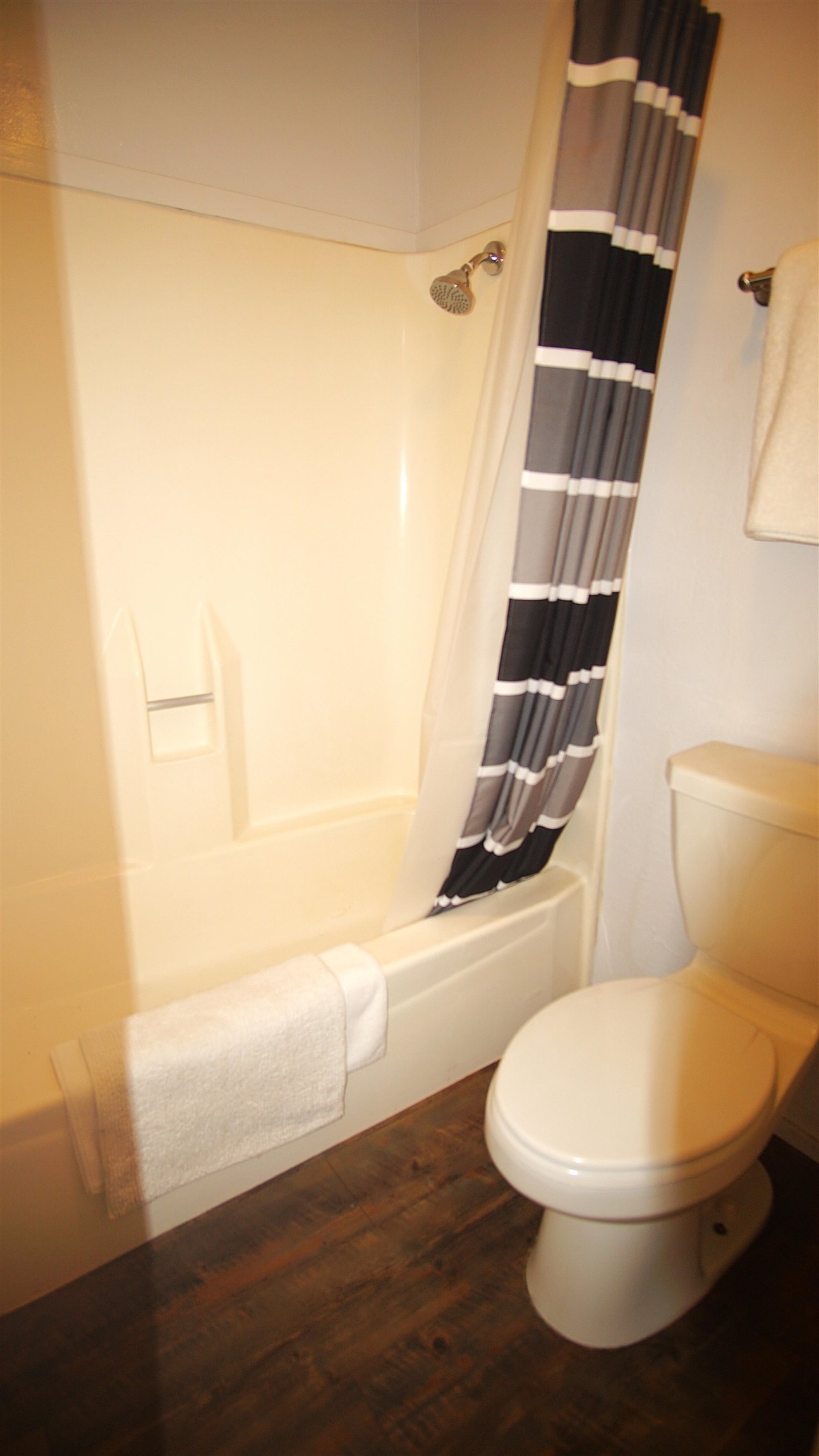 11723 Snowpeak Way, Unit 567 Truckee, CA 96161 - Photo 17 of 28 a white toilet sitting next to a bathroom sink and a tub