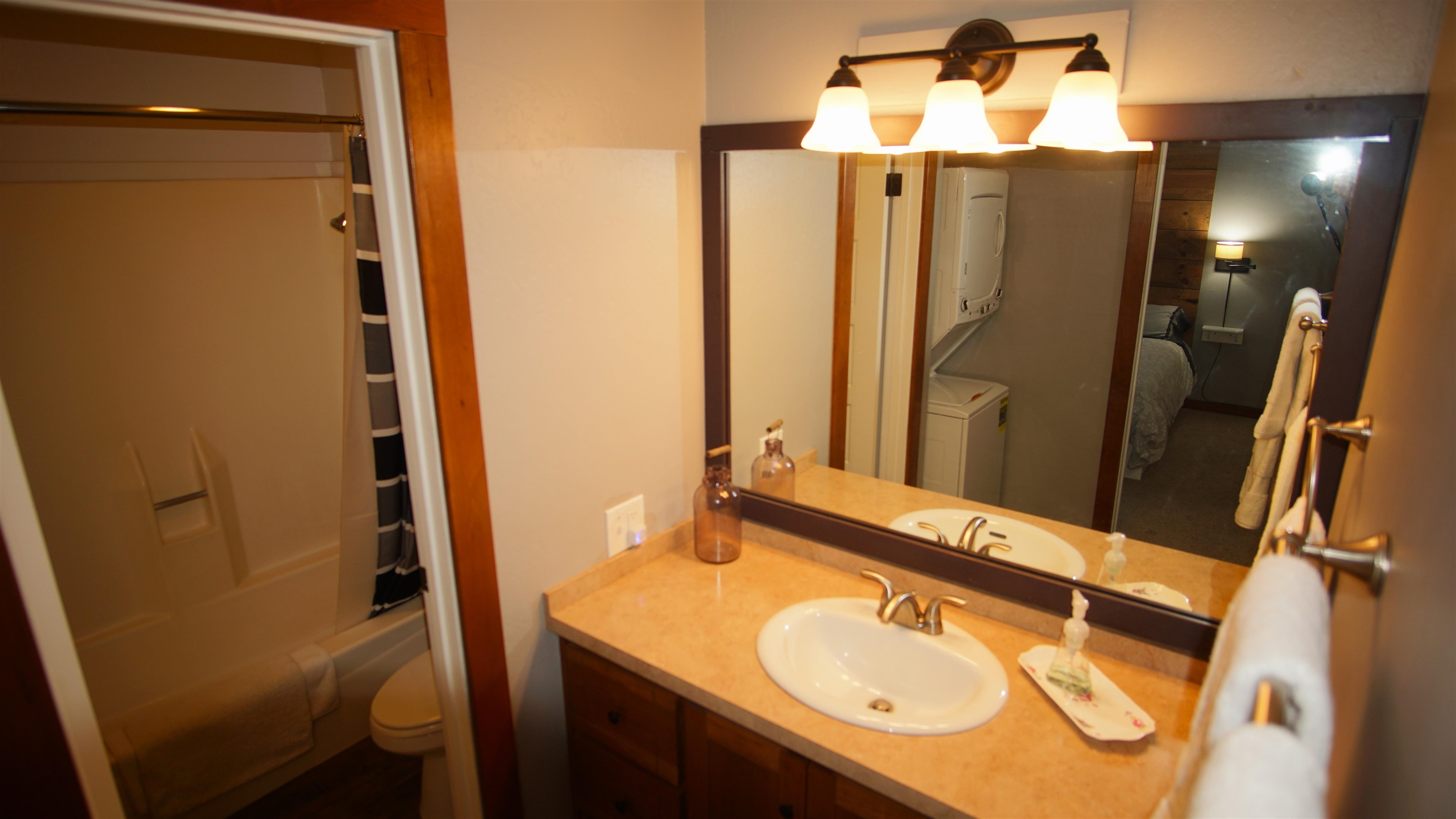 11723 Snowpeak Way, Unit 567 Truckee, CA 96161 - Photo 18 of 28 a bathroom with a granite countertop sink and a mirror