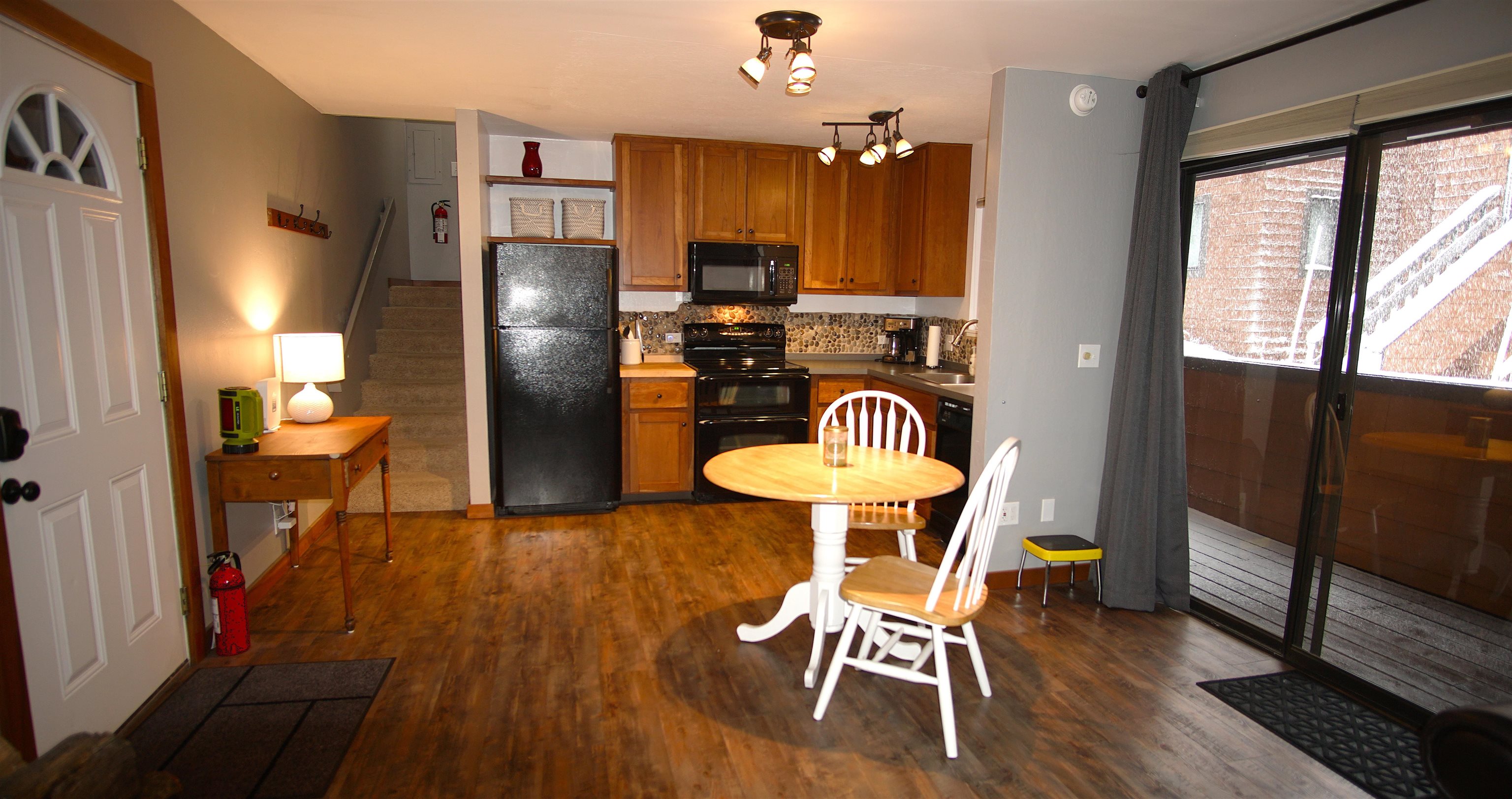 11723 Snowpeak Way, Unit 567 Truckee, CA 96161 - Photo 2 of 28 a dining room with furniture a chandelier and wooden floor