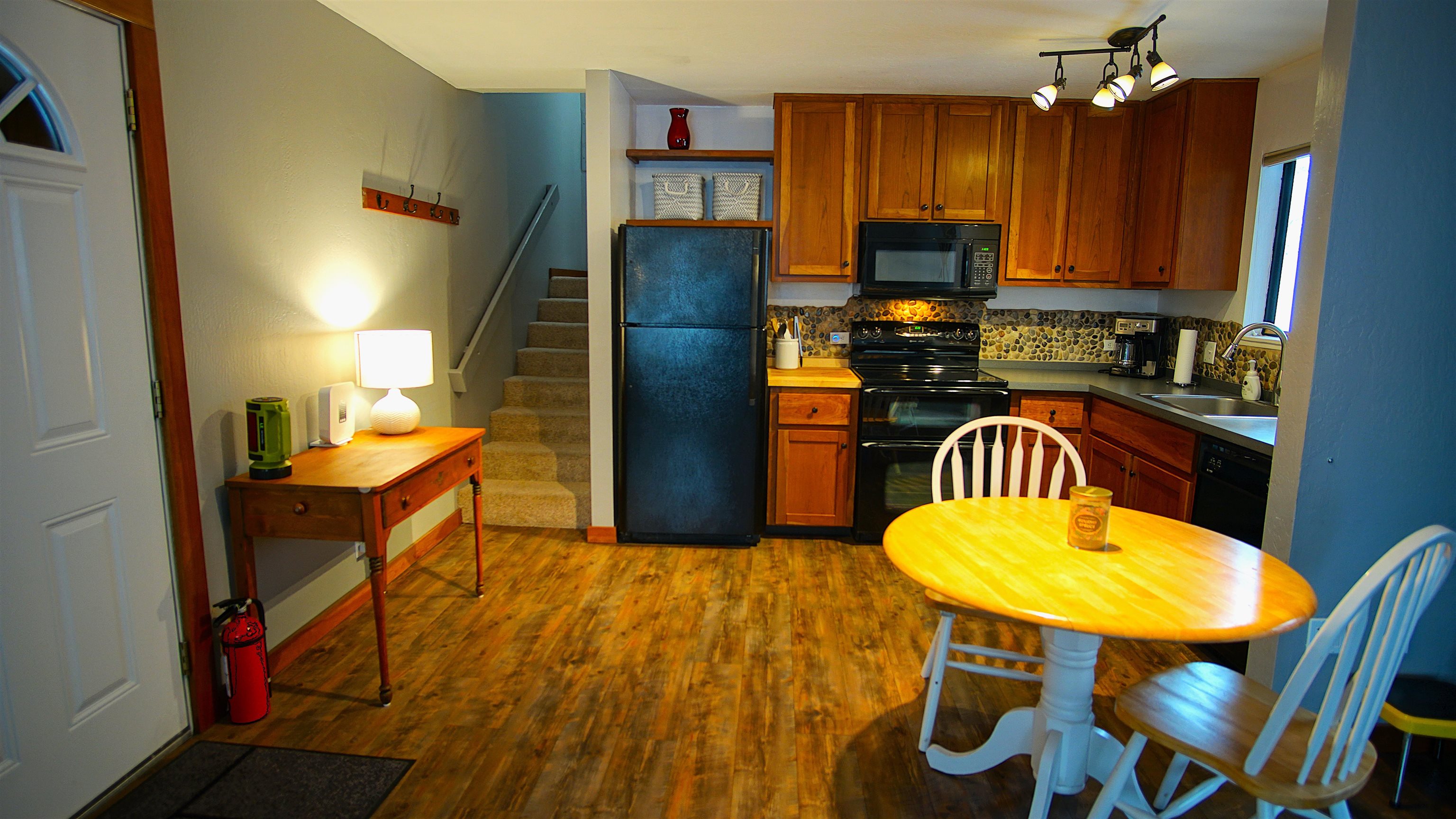 11723 Snowpeak Way, Unit 567 Truckee, CA 96161 - Photo 6 of 28 a kitchen with stainless steel appliances granite countertop a dining table chairs and a refrigerator