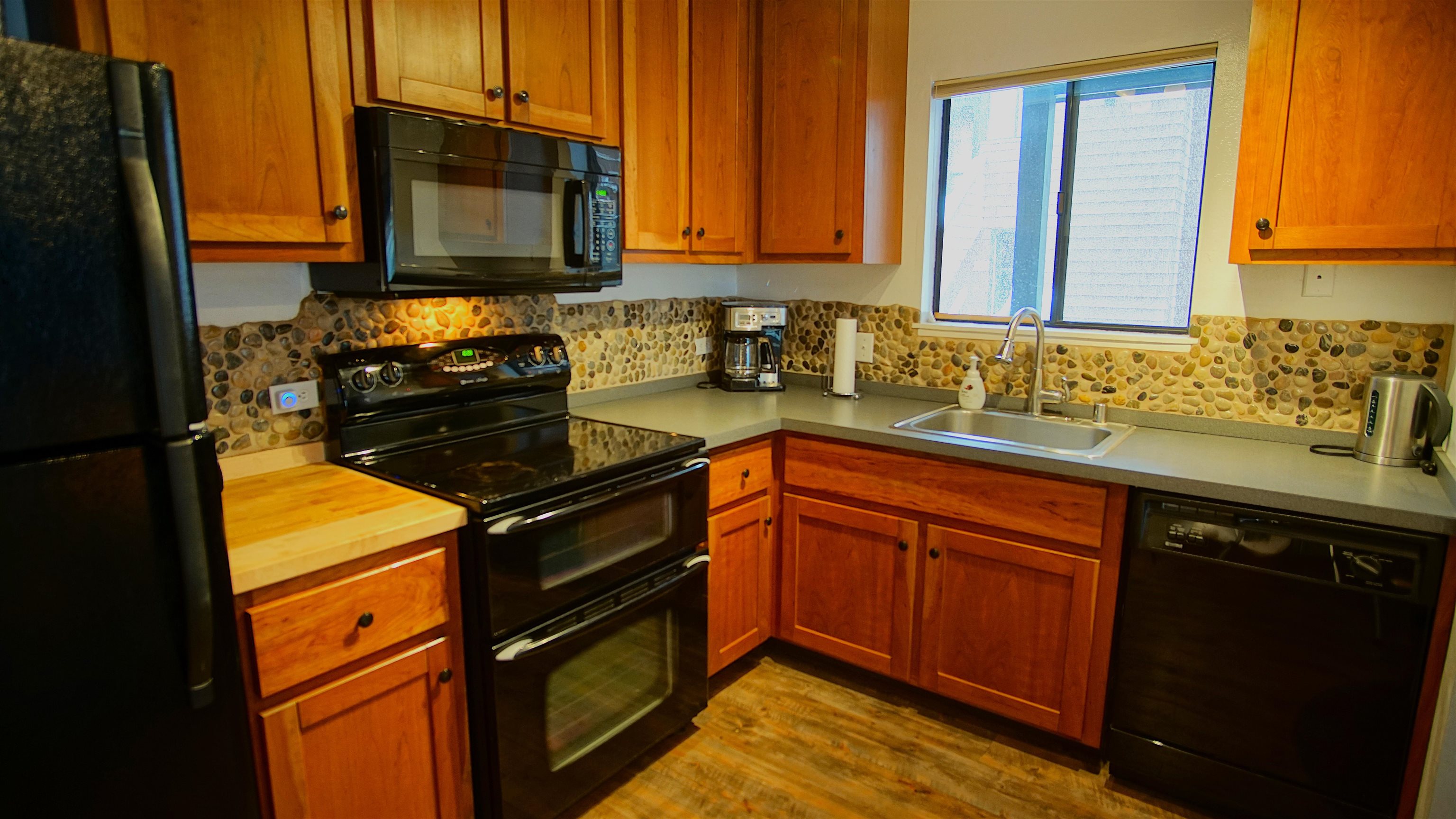 11723 Snowpeak Way, Unit 567 Truckee, CA 96161 - Photo 7 of 28 a kitchen with a sink stove and microwave