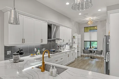 a kitchen with stainless steel appliances kitchen island granite countertop a sink and cabinets