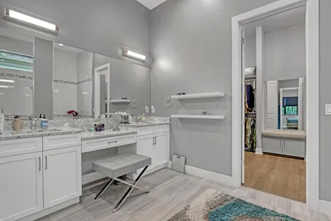 a room with a sink cabinets and wooden floor