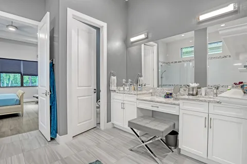 a spacious bathroom with a double vanity sink and a mirror