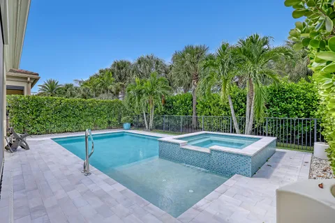 a view of backyard with swimming pool and outdoor seating