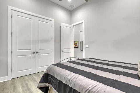 a bathroom with a granite countertop sink a mirror a toilet and shower