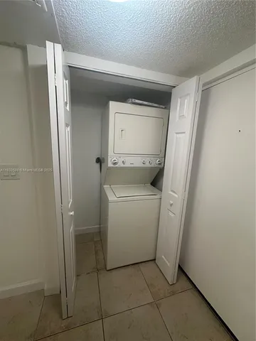 a utility room with cabinets washer and dryer