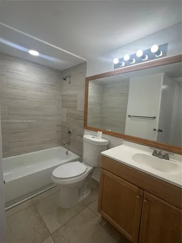 a bathroom with a sink a toilet a mirror and a bathtub