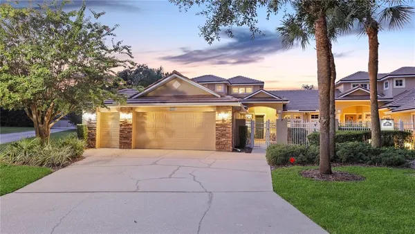 a front view of a house with garden and patio