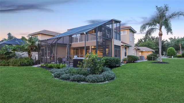 a bedroom with a large bed chandelier and a window