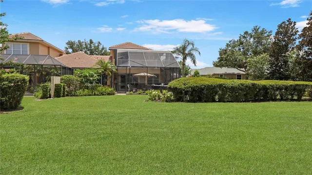 a view of a dining room with furniture a chandelier and window