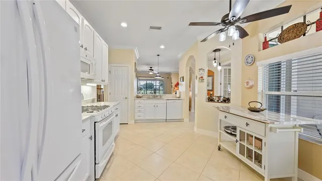 a kitchen that has a lot of cabinets in it and appliances
