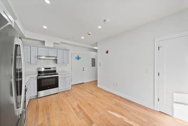 a kitchen with stainless steel appliances granite countertop a refrigerator and a sink