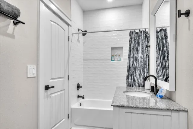 a view of a bedroom with wooden floor