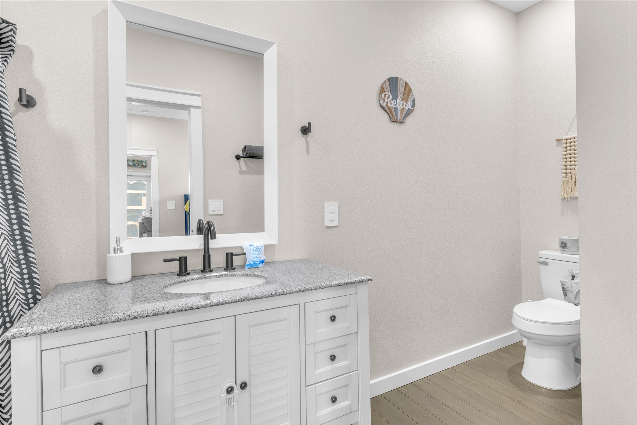 1079 Cedar Lane Port Bolivar, TX 77650 - Photo 22 of 39 a bathroom with a granite countertop sink a toilet and a mirror
