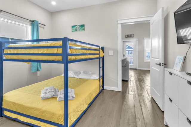 a bedroom with a bed and a view of living room