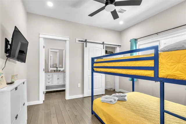 a bedroom with a bed and a large window