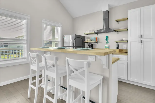 a kitchen with kitchen island a stove a sink and wooden floor