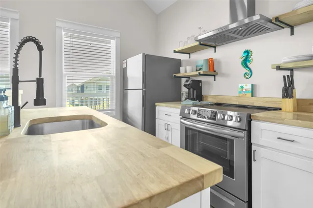 a kitchen with stainless steel appliances granite countertop a sink and cabinets