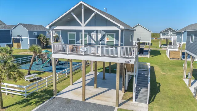 a front view of houses with yard