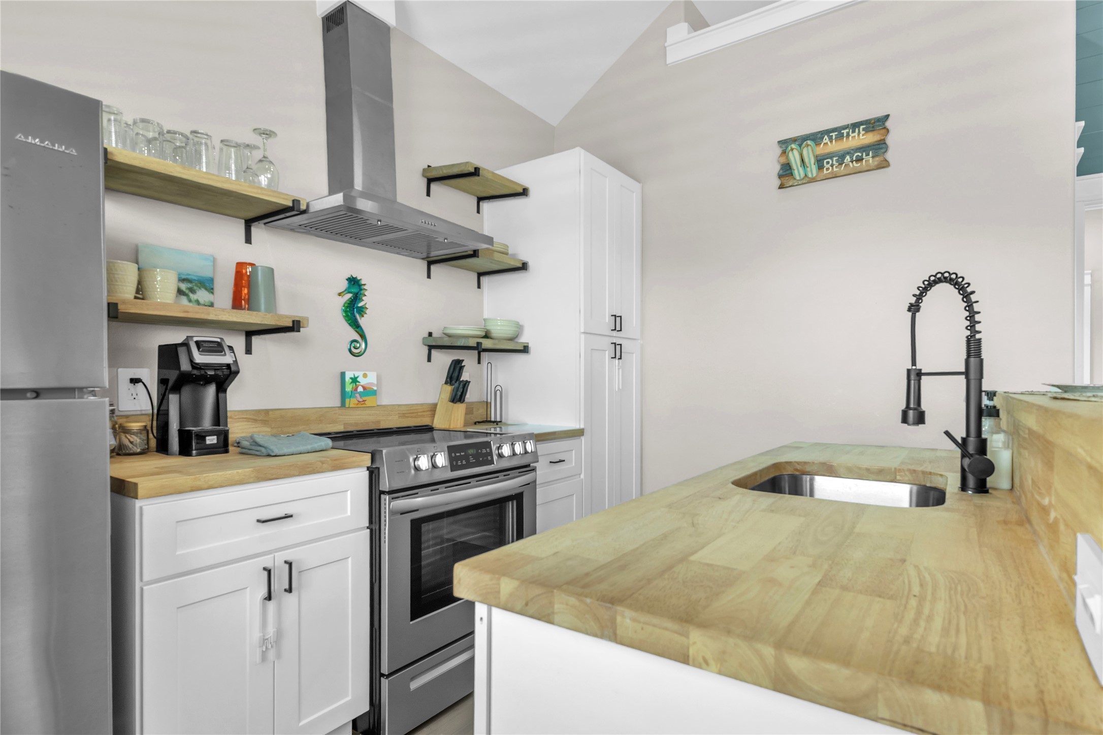 1079 Cedar Lane Port Bolivar, TX 77650 - Photo 31 of 39 a kitchen with kitchen island a stove a sink and wooden floor