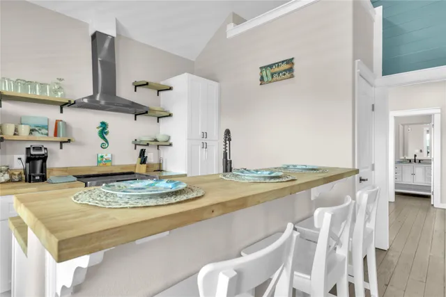 a living room with furniture and a kitchen view