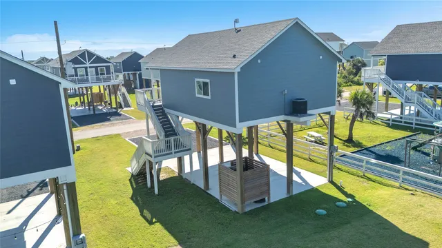 a view of a house with pool and chairs
