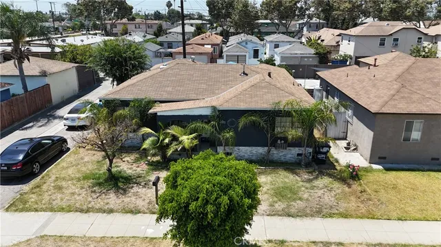 a view of a house with a yard and sitting area