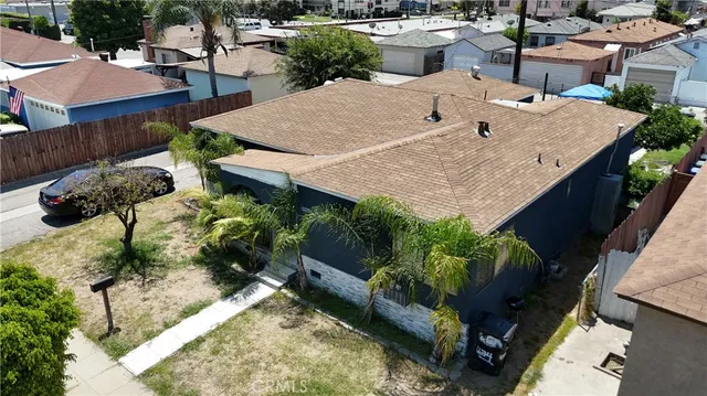 an aerial view of a house with a yard