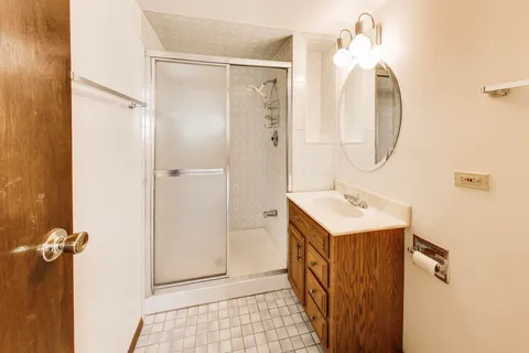 a bathroom with a sink a mirror and a shower