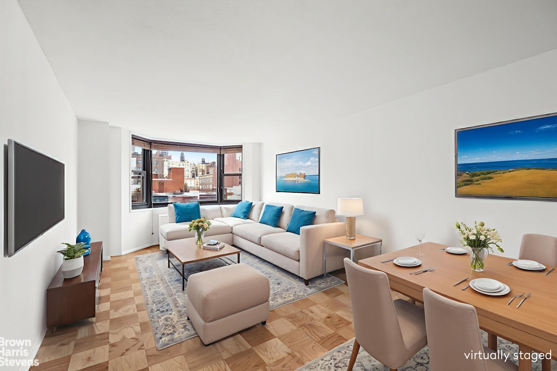 200 East 90th Street, Unit 8A Manhattan, NY 10128 - Photo 1 of 5 a living room with furniture a flat screen tv and a floor to ceiling window