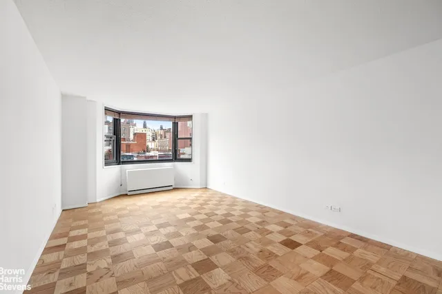 a living room with furniture a flat screen tv and a floor to ceiling window