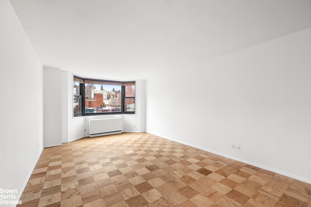 200 East 90th Street, Unit 8A Manhattan, NY 10128 - Photo 2 of 5 a view of a big room with cabinet and mirror