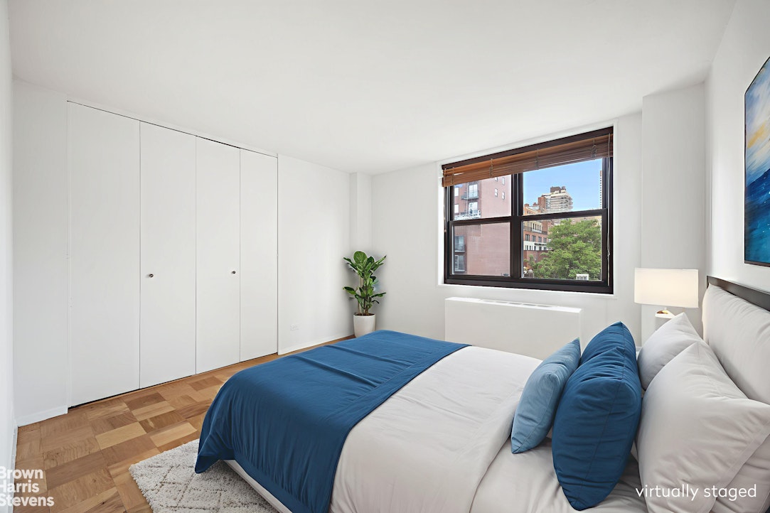 200 East 90th Street, Unit 8A Manhattan, NY 10128 - Photo 4 of 5 a bedroom with a bed and a window with outer view