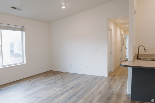 215 South 1050th West, Unit 10 Provo, UT 84601 - Photo 3 of 38 Kitchen featuring light wood finished floors, light countertops, recessed lighting, and a peninsula