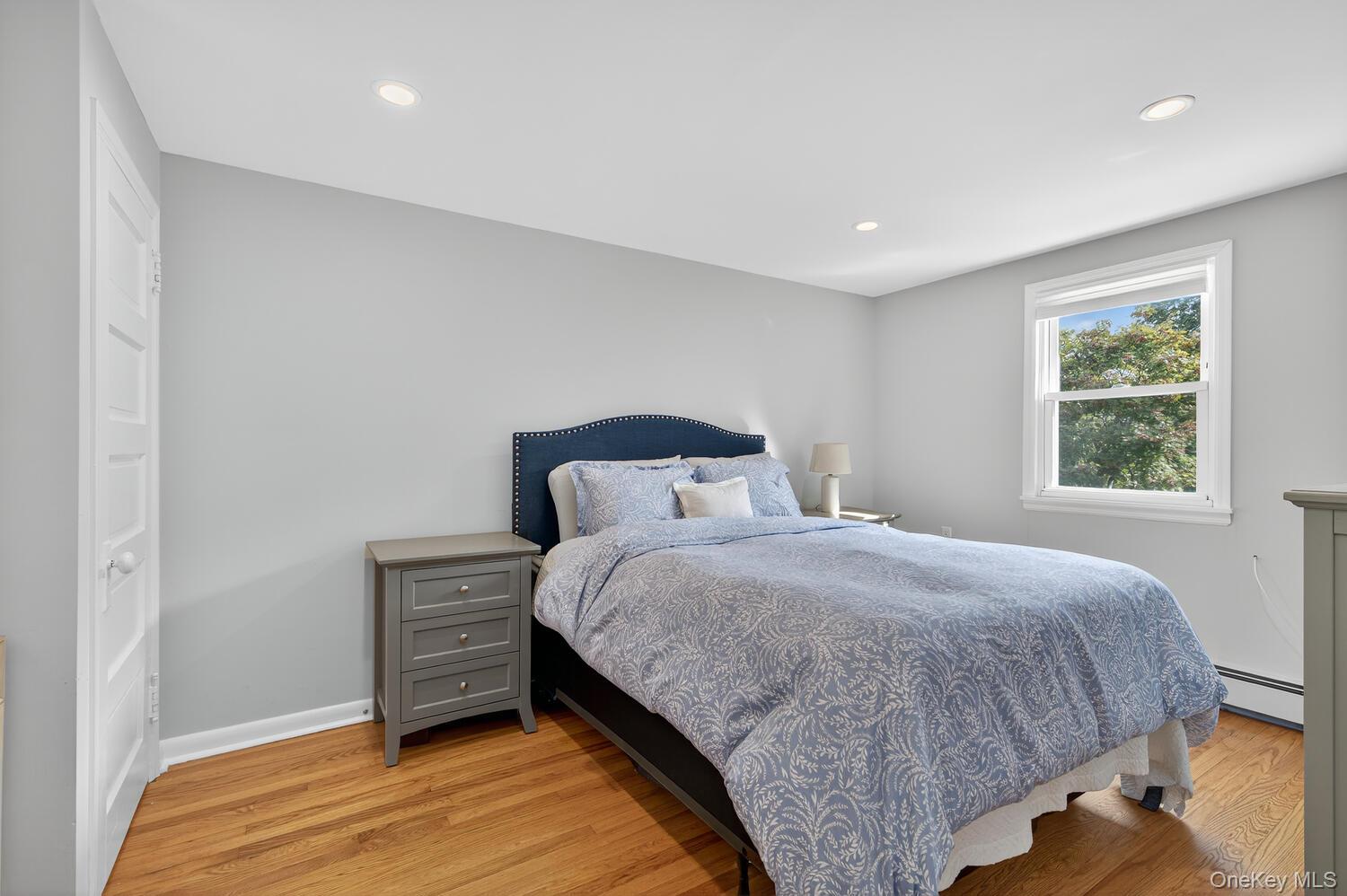 20 Locust Place Locust Valley, NY 11560 - Photo 12 of 16 a bedroom with a bed and a window
