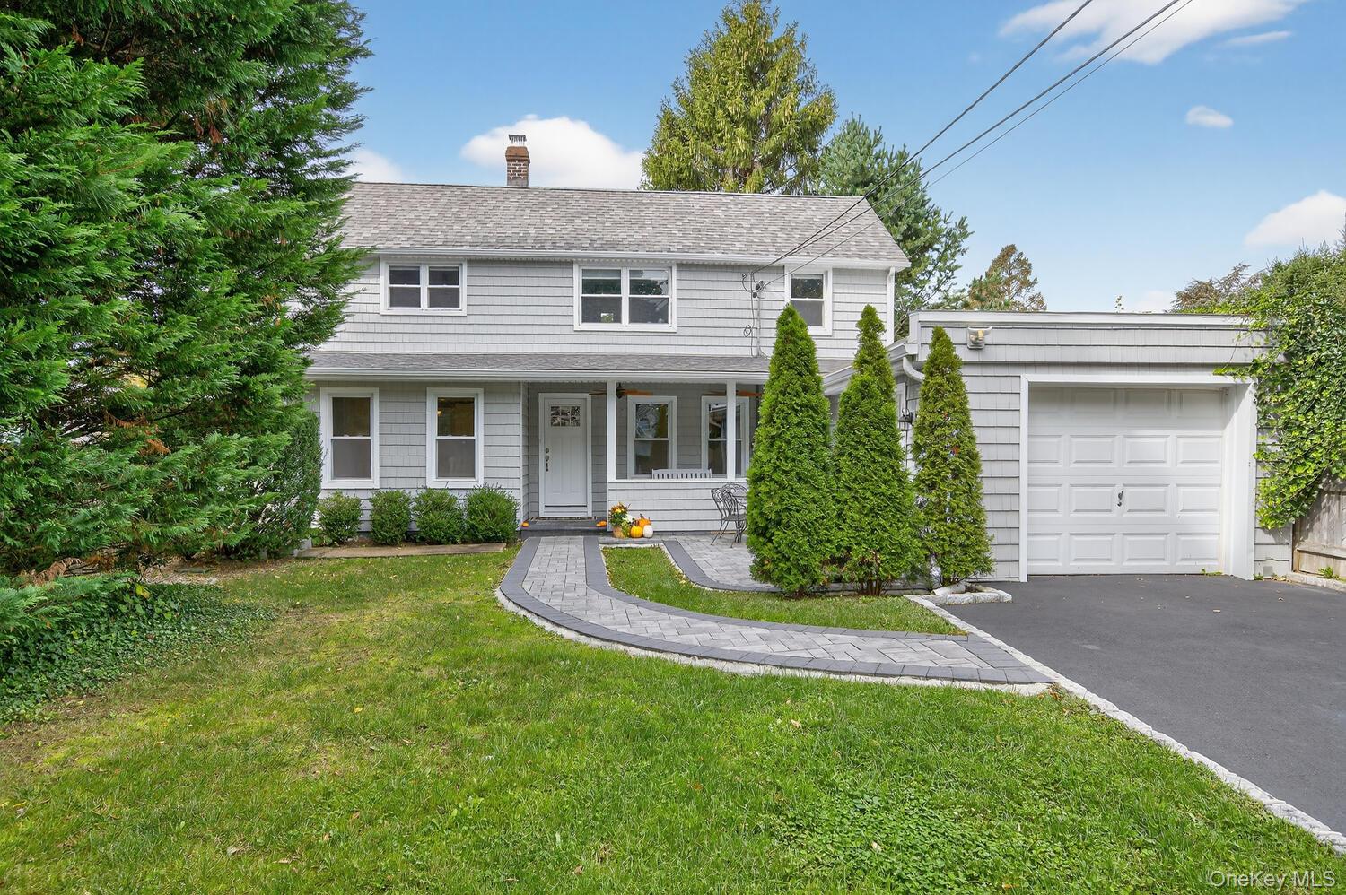 20 Locust Place Locust Valley, NY 11560 - Photo 2 of 16 a front view of a house with a yard