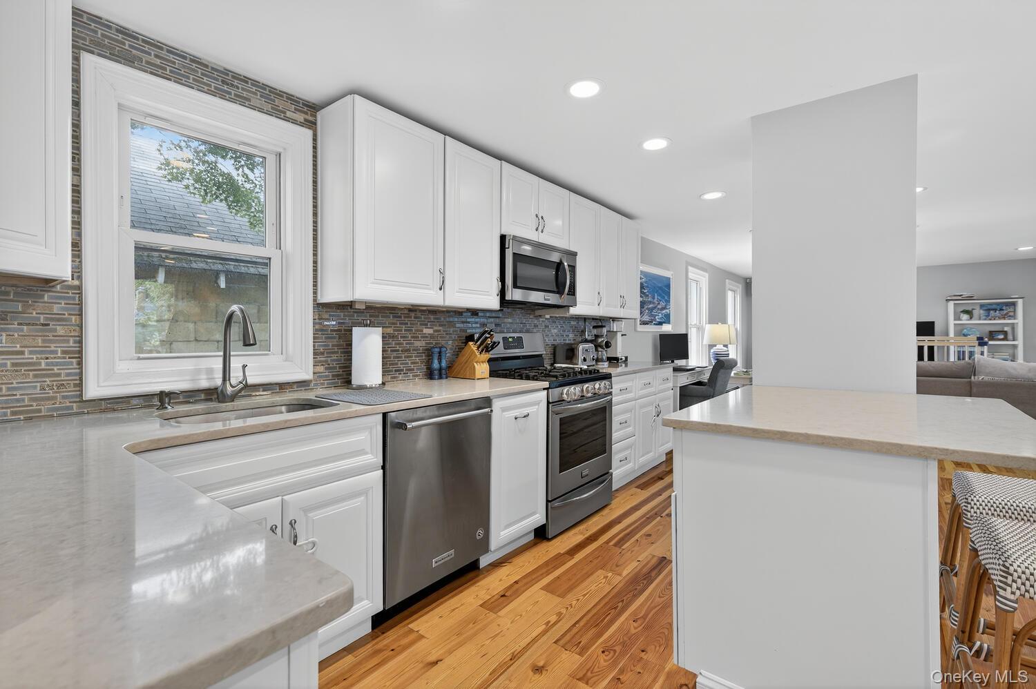 20 Locust Place Locust Valley, NY 11560 - Photo 8 of 16 a kitchen with granite countertop a stove a sink and a microwave