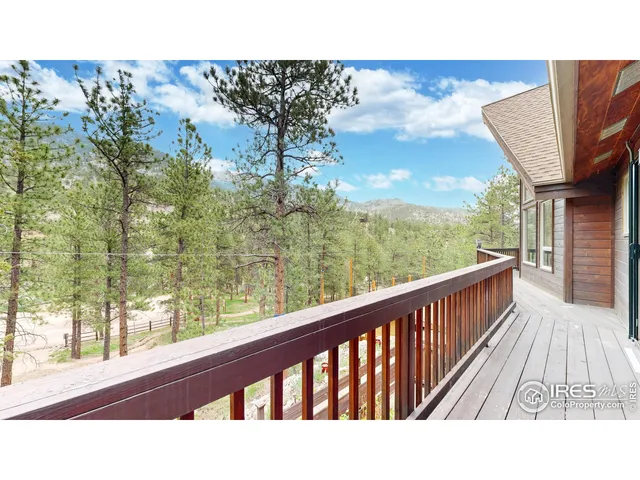 a view of a balcony with a forest