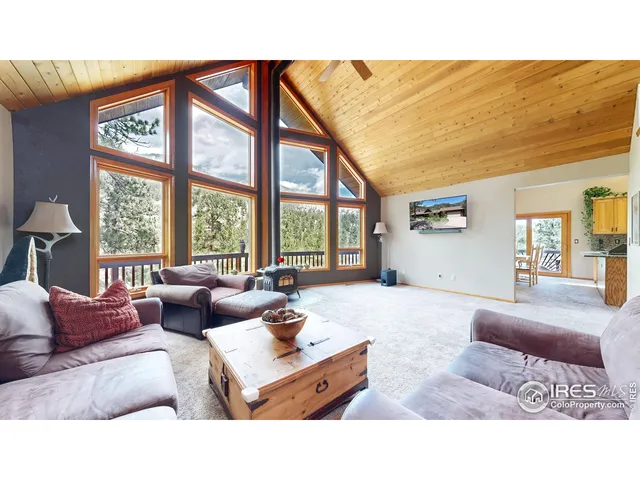 a living room with furniture and large windows