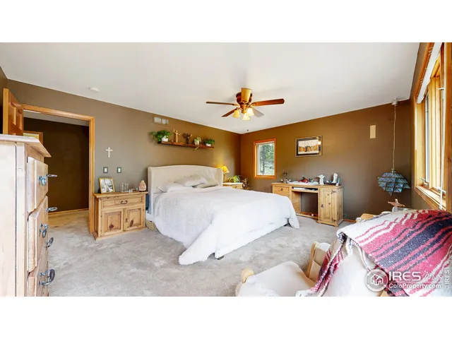 a spacious bedroom with a bed and a chandelier