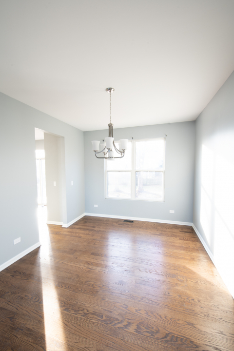 1303 Bridgehampton Drive Plainfield, IL 60586 - Photo 11 of 29 a view of empty room with wooden floor and window