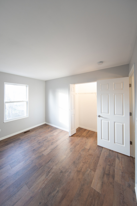 1303 Bridgehampton Drive Plainfield, IL 60586 - Photo 16 of 29 an empty room with windows and closet