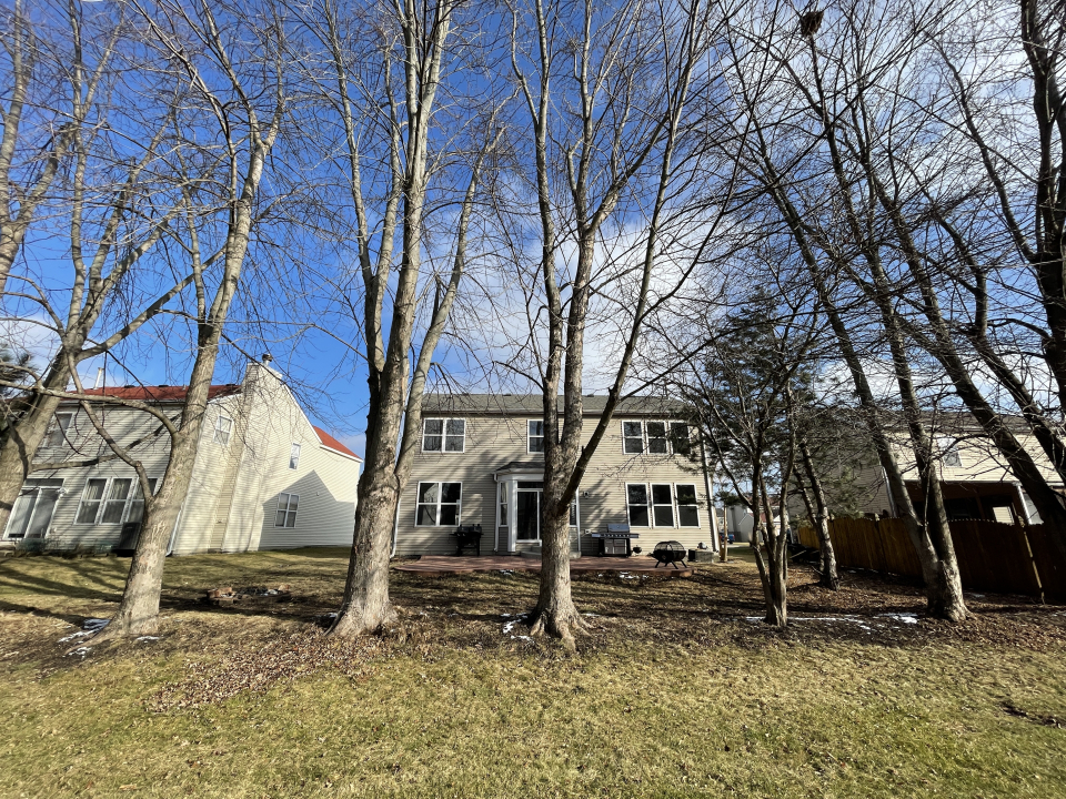 1303 Bridgehampton Drive Plainfield, IL 60586 - Photo 29 of 29 a house with trees in front of it