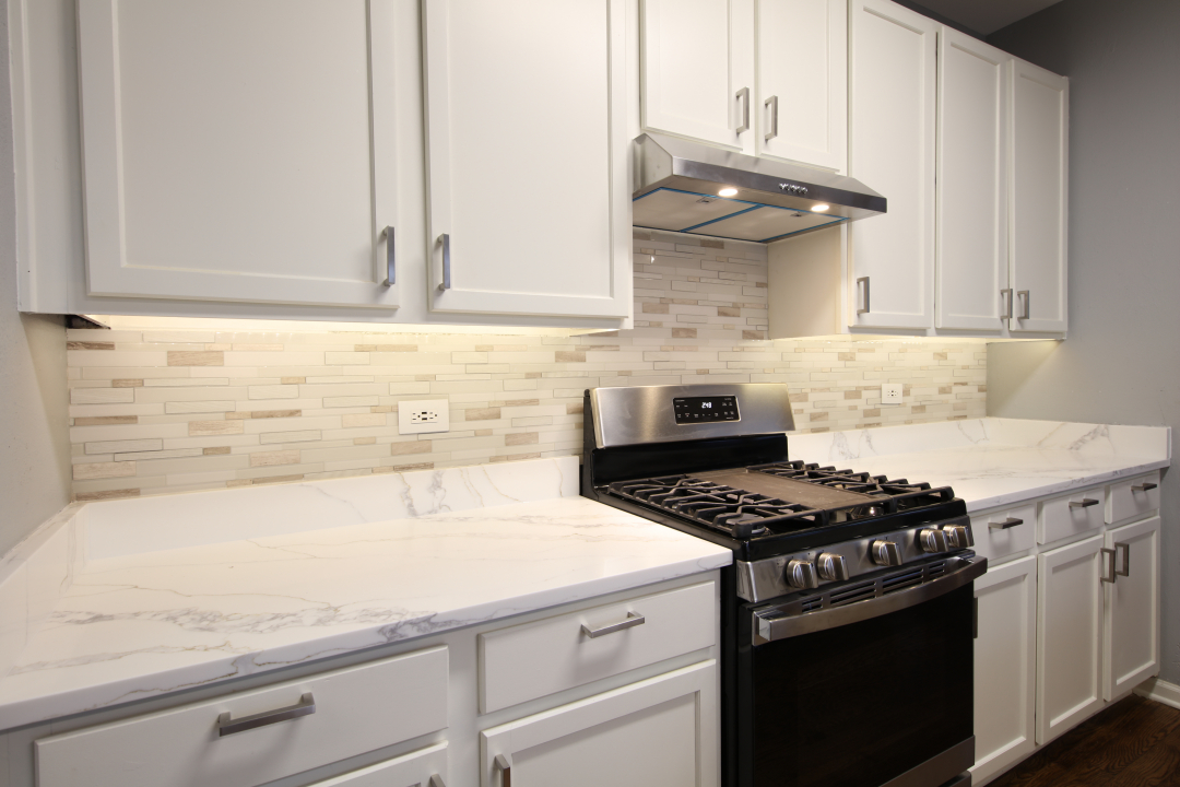 1303 Bridgehampton Drive Plainfield, IL 60586 - Photo 7 of 29 a kitchen with granite countertop a sink stove and cabinets