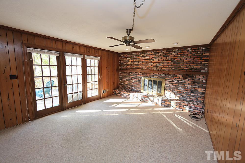 4316 Oak Park Road Raleigh, NC 27612 - Photo 13 of 30 a living room with a large window and chandelier