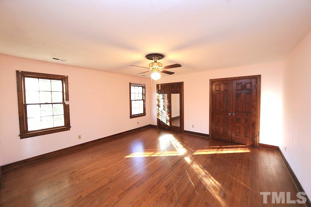 4316 Oak Park Road Raleigh, NC 27612 - Photo 15 of 30 a view of an empty room with window and wooden floor