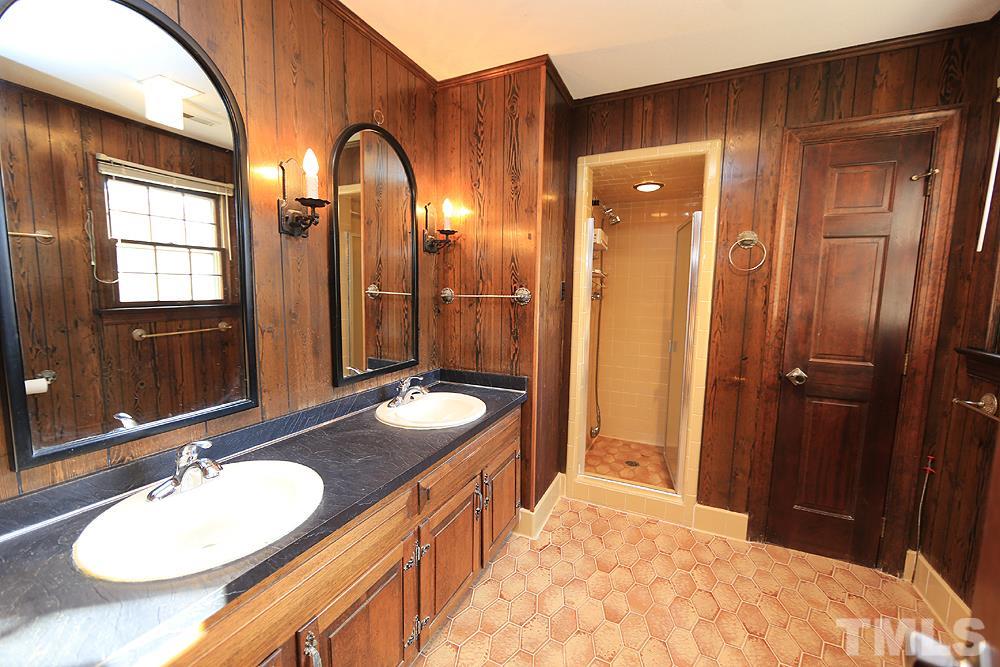 4316 Oak Park Road Raleigh, NC 27612 - Photo 16 of 30 a bathroom with a double vanity sink and a mirror