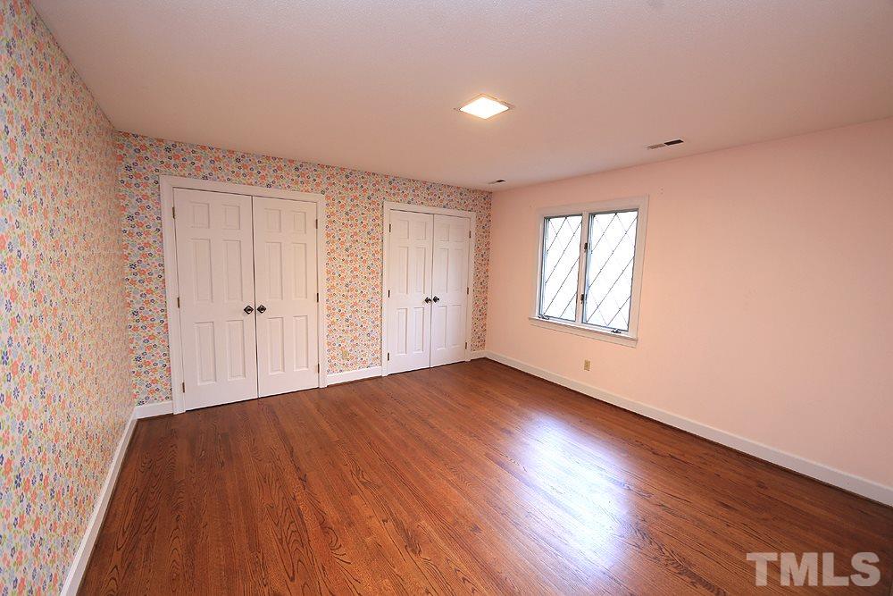 4316 Oak Park Road Raleigh, NC 27612 - Photo 17 of 30 a view of an empty room with wooden floor and a window