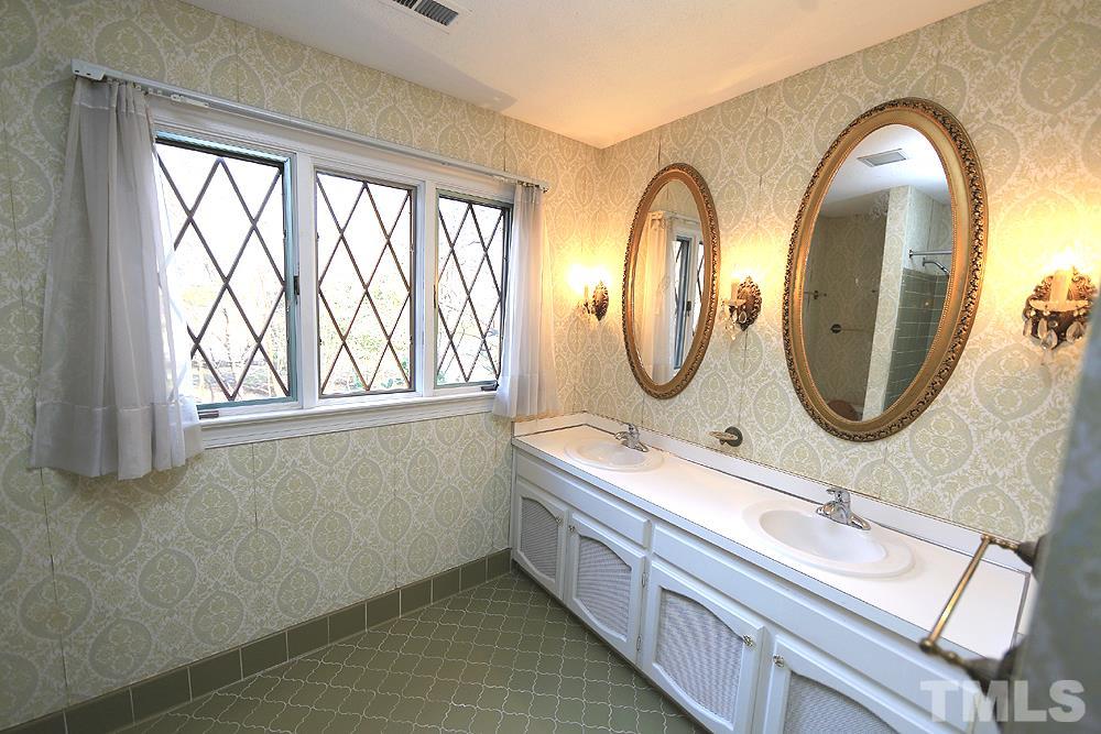 4316 Oak Park Road Raleigh, NC 27612 - Photo 18 of 30 a bathroom with a double vanity sink a mirror and a window